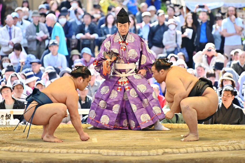 Sumo wrestlers take part in a "honozumo," a ceremonial sumo exhibition, on the grounds of Yasukuni Shrine in Tokyo.