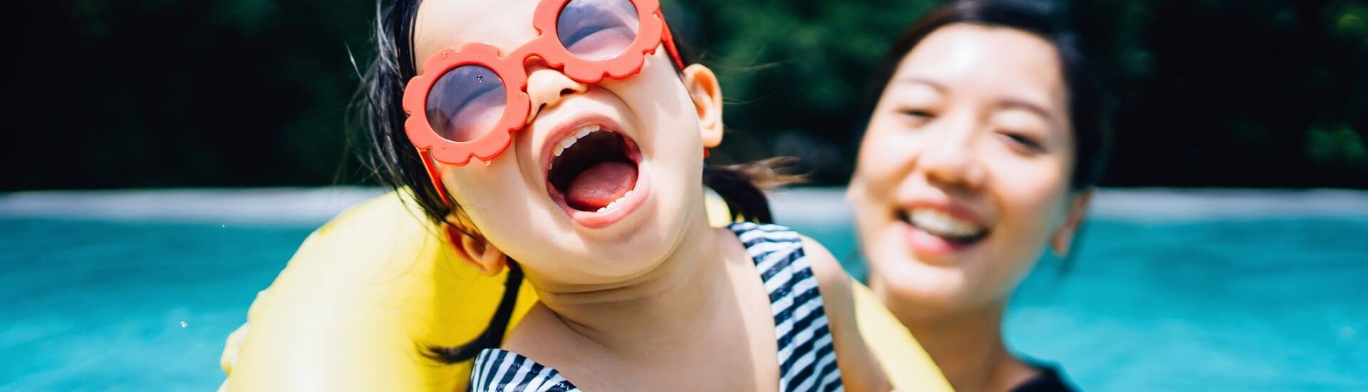 Happy Asian toddler girl with sunglasses smiling joyfully and enjoying family bonding time with mother having fun in the swimming pool in summer
1181462163
Downloaded June 2021